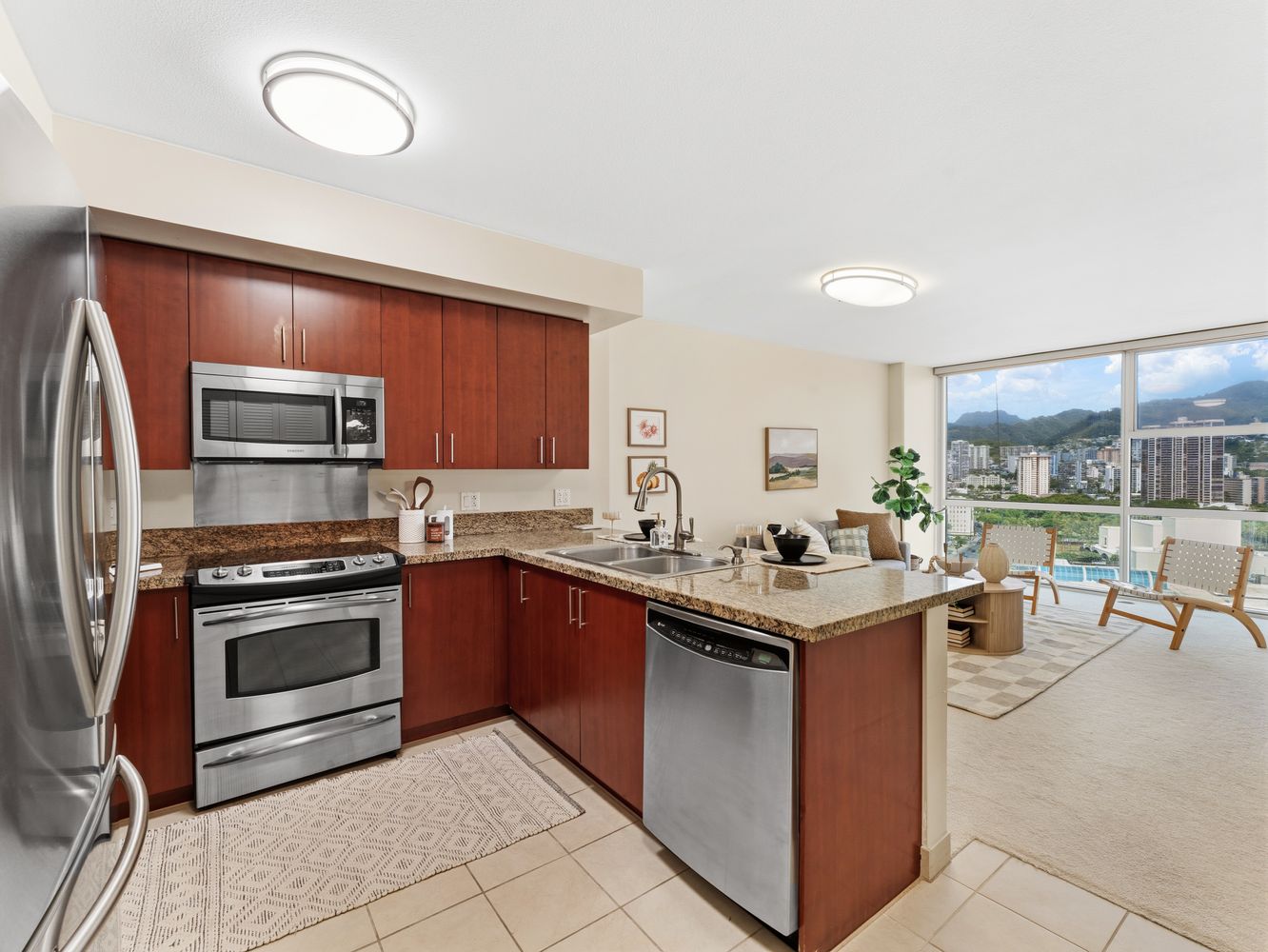 Kitchen with cherry cabinets, granite counters and stainless appliances opening to the living room
