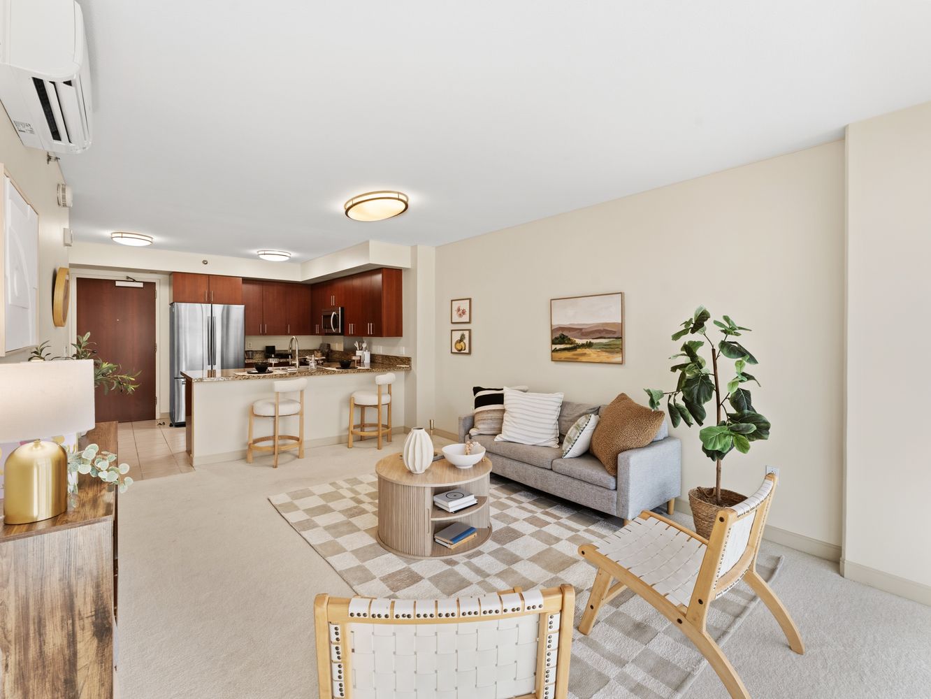 Entry view of the living room and kitchen with cherry cabinetry and counter seating